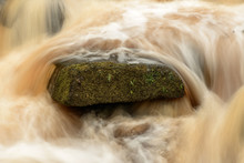 Stock Image Of A Running River Through Moss Covered Rocks In Pad