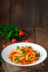 Wall Mural - Penne pasta in tomato sauce with chicken, tomatoes