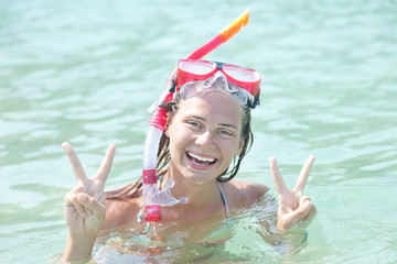 Wall Mural - woman with a mask for snorkeling in the sea background