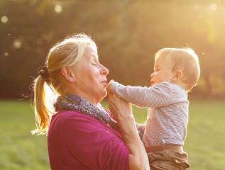 Grandmother with her grandson playing in the park