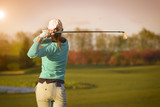 Fototapeta Desenie - Woman golf player hitting ball.