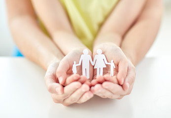 Poster - close up of woman and girl hands with paper family