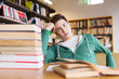 © Syda Productions - bored student or young man with books in library