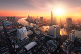 Bangkok city sunlight warm orange,sunrise in morning rooftop view, chao phraya river the office buildings in Bangkok city  skyline top view business office in capital city of Thailand Asian 