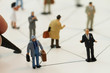 © everythingpossible - close up of miniature people with social network diagram on open