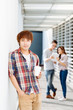© DragonImages - Young man with take-out coffee