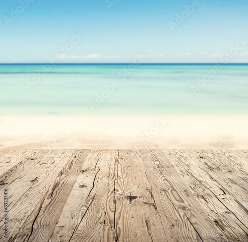 Empty wooden pier with view on sandy beach