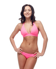 happy young woman in pink bikini swimsuit