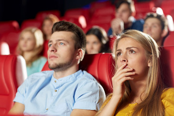 Wall Mural - happy friends watching horror movie in theater