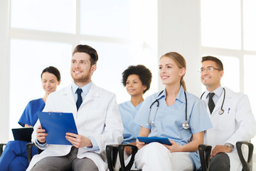 Poster - group of happy doctors on seminar at hospital