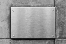 Blank Metal Sign Or Nameboard On Concrete Wall