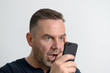 © michaelheim - Nachdenklicher attraktiver Mann mit Handy