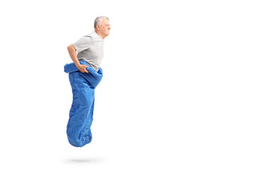 Sticker - Senior man jumping in a blue sack and smiling