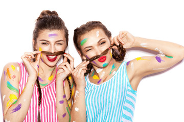 two lovely painted girl friends having fun