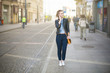 © innervisionpro - Woman talking on the phone on city promenade