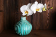 white orchid on wooden background