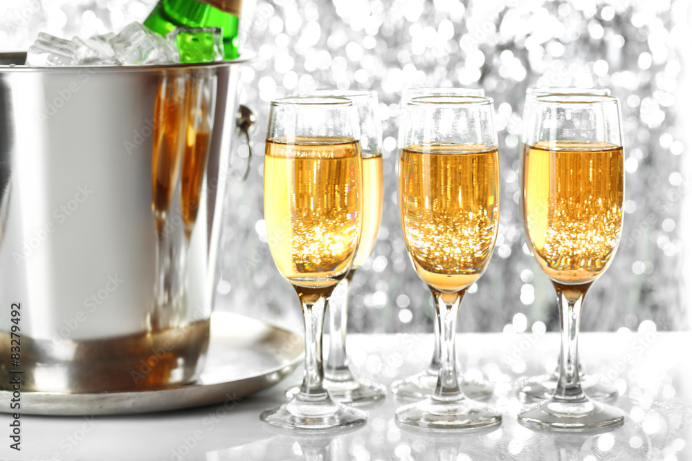 Glasses of champagne on bright background