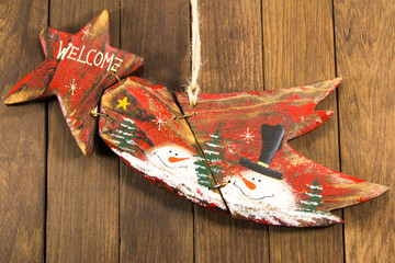 Hanged red wooden decoration comet star shaped on wooden backgro