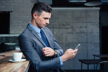 Poster - Businessman using smartphone in cafe