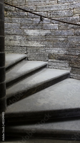 Fototapeta na wymiar stone steps of the spiral staircase to the top