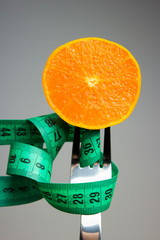 orange fruit and measuring tape