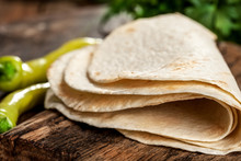  Tortillas On A Wooden Table