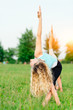© michelangeloop - Yoga. Two young women doing yoga exercise outdoor