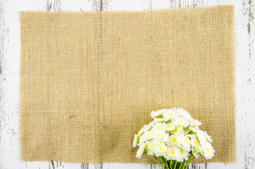 Poster - Fresh flowers on jute background