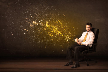 Wall Mural - Businessman with tablet and energy explosion on background