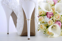 Wedding Ring On Beautiful White Stiletto Shoe Heel.