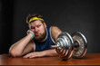 Sad man with a dumbbell
