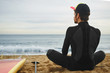 © wayhome.studio  - Portrait of handsome young surfer man sitting at sand near ocean
