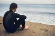 © wayhome.studio  - Portrait of handsome young surfer man sitting at sand near ocean