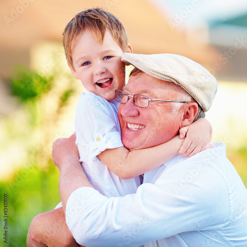 Portrait Of Happy Grandpa And Grandson Embracing Outdoors Buy This 
