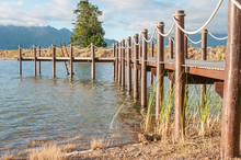 Repeating Pattern Of Wooden Poles In A Jetty