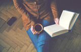 Fototapeta  - girl reading book and drinking fresh coffee