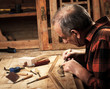 Senior carpenter restoring old furniture