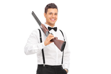 Poster - Elegant guy holding a shotgun over his shoulder isolated on whit