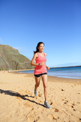 Wall Mural - Runner sports athlete running woman on beach