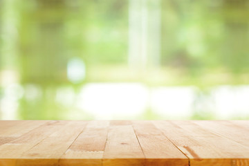 Wall Mural - Wood table top on blurred green background