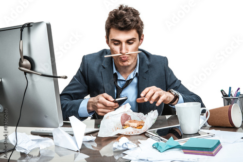 Fotografering Slacker man using smartphone while getting hamburger