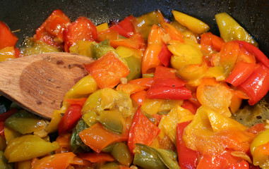 tasty peppers in the pan with a spoon