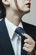© RooM The Agency - Woman in suit holding her tie