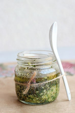 Homemade Pesto Sauce In Glass Jar And Porcelain Spoon