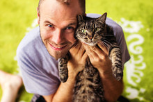 Portrait Of Man With Tabby Cat