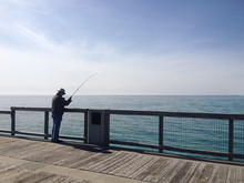 Man In Pier Fishing