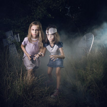 Two Girls Pretending To Be Zombies In A Cemetery