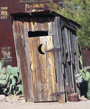 An Old Mining Camp Outhouse In The Desert