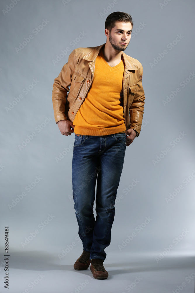 Portrait of young man on gray background