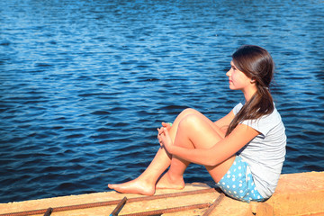 teenager beautiful girl on the country summer lake background